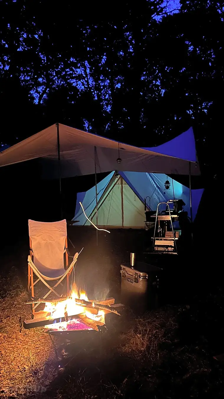 A campfire burning in a stone-ringed fire pit